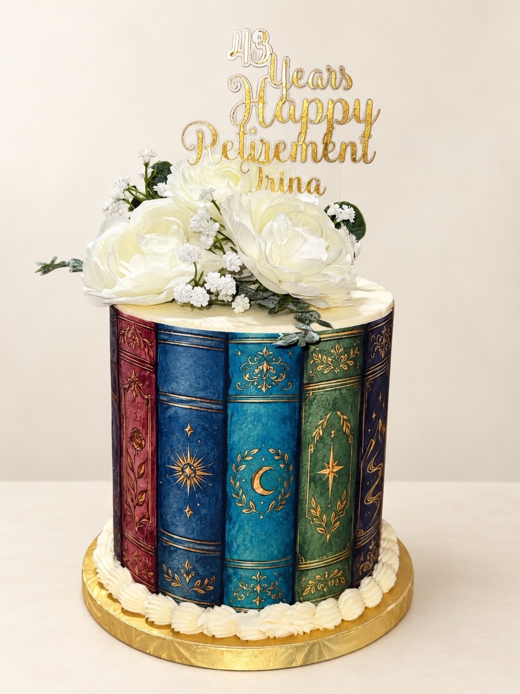Retirement cake decorated with book spines and white flowers