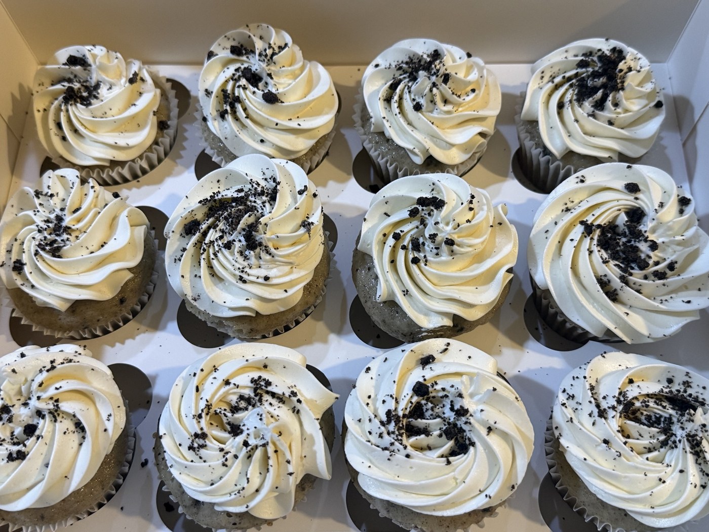 White frosted cupcakes with cookie crumbs
